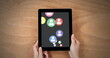 Hands clutch tablet showing vibrant social media icons