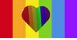 A large heart showing in front of rainbow-colored background