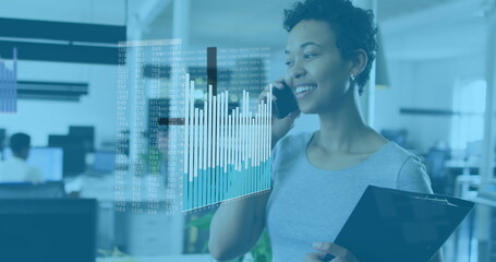 Poster - A biracial colleague with curly hair is talking on phone, holding tablet