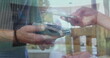 Caucasian colleague holding smartphone over payment terminal