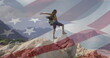 Biracial woman on rock with American flag.