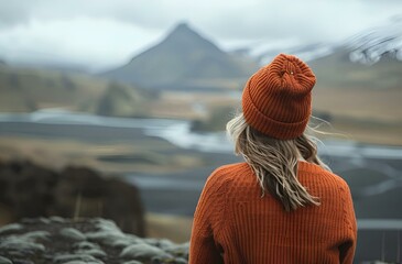 Wall Mural - AI generated illustration of a woman in a hat standing on a mountainside