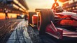 Red single-seater race car on track at sunset