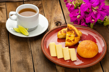 Sticker - Colombian food - Arepa boyacense for breakfast, accompanied with cheese, almojabana and aguapanela with lemon