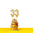 Birthday candle number 33 - Cupcake on white background