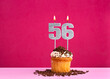 Birthday cupcake with candle number 56 - Birthday card on pink background