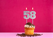 Birthday cupcake with candle number 58 - Birthday card on pink background