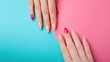 Two hands with stylish manicured nails over dual-tone background