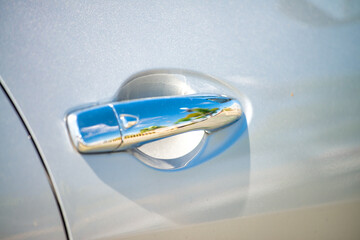 Poster - A car door handle, reflections