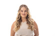 Young caucasian female plus size model standing on white background, wearing sleeveless top, smiling
