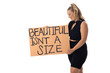 Caucasian young female plus size model holding poster, wearing black outfit on white background