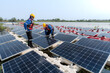 © ultramansk - Male workers repair Floating solar panels on water lake. Engineers construct on site Floating solar panels at sun light. clean energy for future living. Industrial Renewable energy of green power.