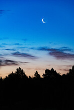A Crescent Moon In The Early Morning Sky Over Clayton Lake State Park, New Mexico