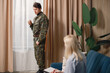 Soldier in military uniform talking to psychiatrist at therapy session