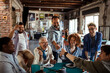© Davor - Multigenerational and diverse group of people celebrating a birthday in a startup company office