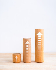 Poster - Arrows upward on cylindrical wooden bar graph steps isolated on white background, vertical style, business growth process, profit planning, success investment goal chart, growing market concepts.