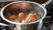 boiling eggs in stainless pot, eggs in boiling water
