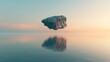 Surreal view of lone floating boulder mirrored in the serene waters at dawn