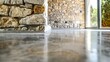 Upclose shot of weathered stone walls meeting a polished concrete floor illustrating the contrast between ancient and modern building techniques. .