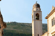 Bell-tower with hill background under blue sky Croatia