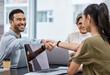 © peopleimages.com - Business people, handshake and deal in meeting for unity, teamwork and partners for merger. Colleagues, welcome and agree on contract or plan in boardroom, hiring and onboarding or recruit client