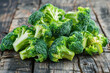 pile of sliced broccoli on wooden table. closeup view. broccoli is vegetables for diet and healthy eating. organic food.