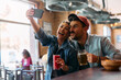 Carefree couple having fun while taking selfie in pub.