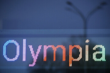 Olympia written on a LED screen in rainbow colors