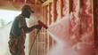 Focus on the installer: An insulation installer, masked and suited, battles a cloud of pink fluff to create a cozy haven within a construction site.