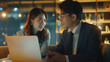 © Jameswa - A diverse group of businesspeople work together on laptops in a bright, modern office