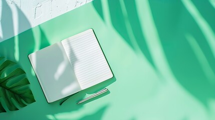 Aufkleber - Office notebook with blank pages lying open on two tone or bicolor green and white background with leaf of a potted plant and pen in a creative flat lay still life : Generative AI