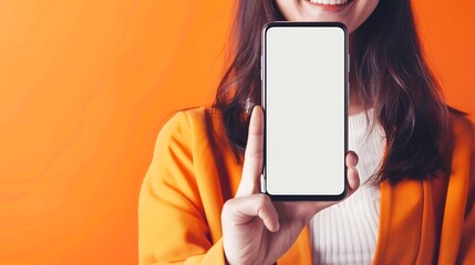 Aufkleber - App Ad Smiling pretty woman holding smartphone with white blank device screen in hand close up to camera orange studio Gadget with empty free space for mockup banner isolated selective : Generative AI