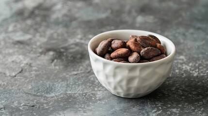 Poster - Roasted cocoa beans in a white bowl On a gray stone background Side view : Generative AI