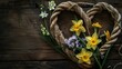 Upon the dark wood table lay a rustic heart shaped arrangement of rough natural rope intertwined with delicate daffodils and hyacinths