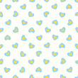 Vector illustration. Seamless pattern of small yellow-blue hearts on a light milky white background. Textile printing, fabric design, packaging, wrapping paper, children's wallpaper