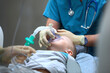 An anesthesiologist holds a breathing mask over the face of a young boy. Introduction to General anesthesia before surgery. The device of artificial ventilation of lungs