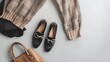 Brown pants in check beige knitted oversize sweater cross body bag black loafers or flat shoes on grey background Overhead view of womens casual day outfit Flat lay top view Women clot : Generative AI
