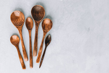 Wall Mural - Wooden spoons. Wooden spoons on gray stone background, kitchen concept.