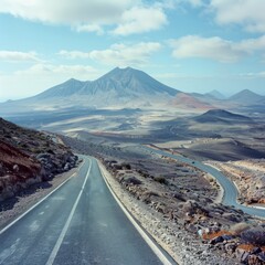 Poster - A road with a mountain in the background. The road is empty and the sky is clear