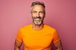 © Markus Schröder - Portrait of a cheerful man in his 40s wearing a moisture-wicking running shirt on solid color backdrop