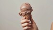 Fresh and appealing photo of a hand holding a freshly scooped chocolate ice cream, perfect for summer campaign, isolated background, studio light