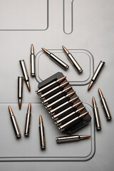 Wall Mural - .223 caliber cartridges in silver cases on brushed metal. Ammunition for weapons. Light back