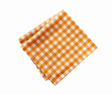 Fototapeta Tulipany - Folded checked yellow tablecloth isolated on white.Picnic orange cloth,dish towel,food decor.