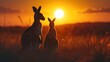 A kangaroo and its joey silhouetted against the Australian outback sunset