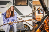 Fototapeta Zachód słońca - Girl Enjoying Her Summertime Next to Campfire