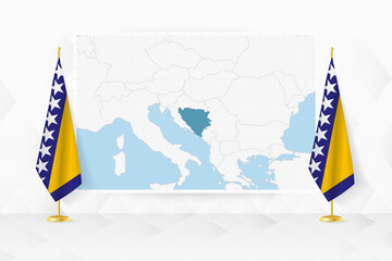Wall Mural - Map of Bosnia and Herzegovina and flags of Bosnia and Herzegovina on flag stand.