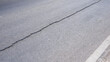 Crack line texture on surface of asphalt road background, high angle and side view with copy space