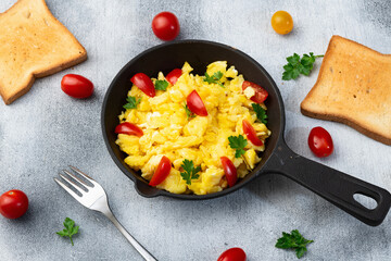 Wall Mural - Healthy vegetarian breakfast . Scrambled eggs toast with cherry tomatoes and parsley