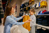 Fototapeta Nowy Jork - Loving mother and little son doing purchases in shopping mall