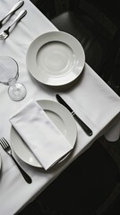 A black and white photo of a table set with two place settings.